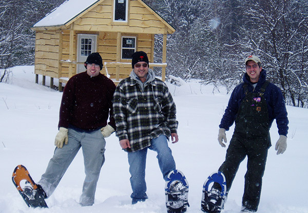 Camping Pictures ny Men Snowshoeing From Land And Camps