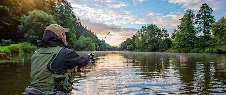 buy land in ny image of man fishing on river