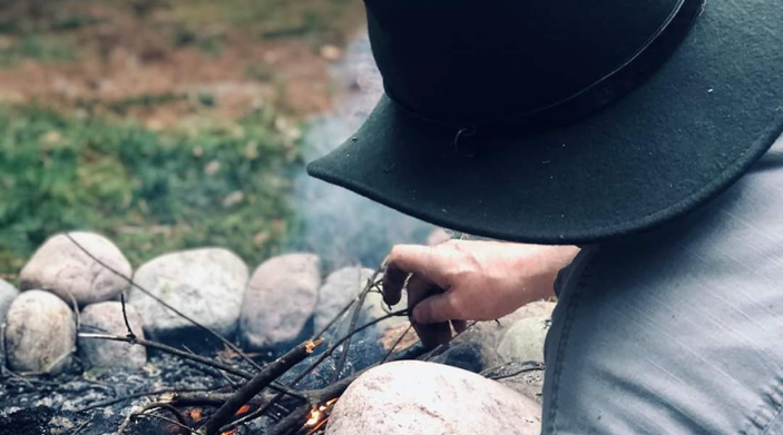 Person doing project x with the campfire in ny state land and camps