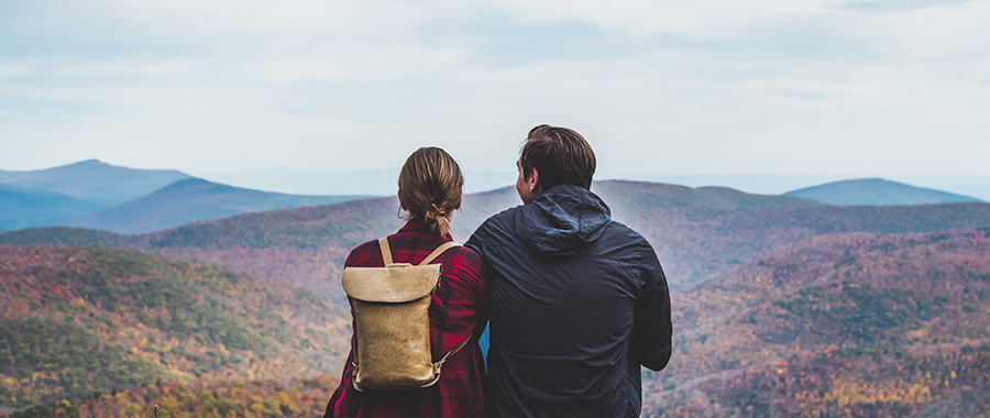 off the grid property for sale ny state image of couple looking out at adirondack mountains