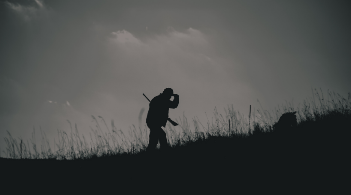 end of hunting season and man walking through hunters field in ny state